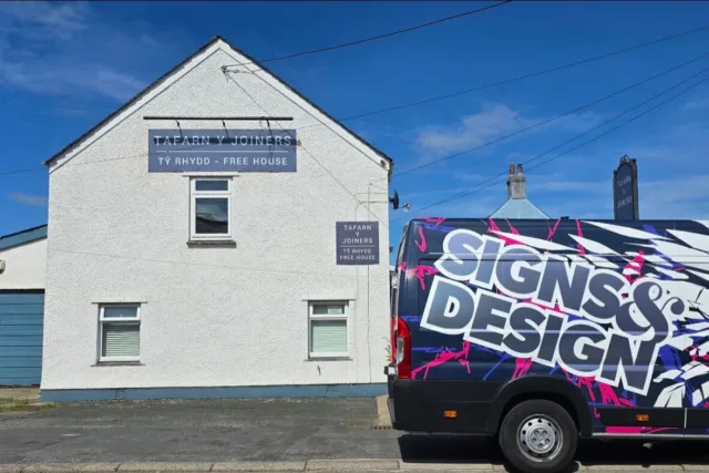 Exterior signage for Tafarn Y Joiners free house pub alongside a branded Signs & Design van with bold vehicle graphics