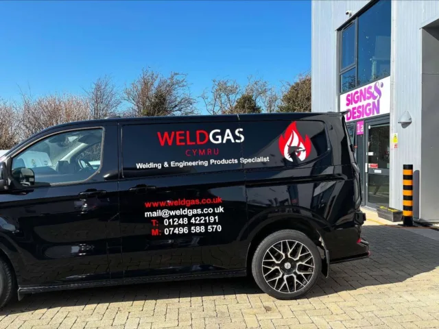 Vehicle wrap signage for Weld Gas Cymru van with company logo, contact details, and welding services branding