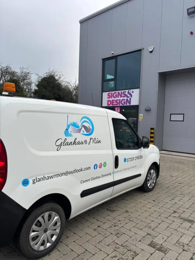 White van with Glanhawr Môn branding for domestic cleaning services, parked outside Signs & Design